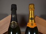 two bottles of champagne sitting next to each other on a table