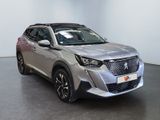 the front view of a silver suv parked in a showroom