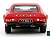 a red car that is sitting on a white surface