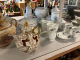 many different types of teapots and cups on the table
