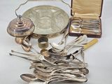 a lot of silver spoons and silverware on the table