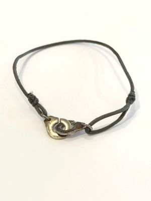 leather cord bracelet with a brass clasp on a white background