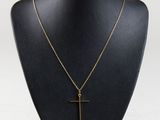 a black mannequin with a gold cross on it