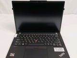 the laptop is open on a white surface with a black keyboard