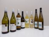 several bottles of wine are lined up on a table