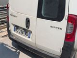 a white van parked in front of a building