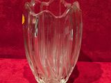 a glass vase that is sitting on a red surface