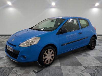 the small blue car is parked in the garage on a checkered floor