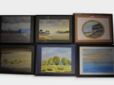 six framed pictures of different landscapes on the wall