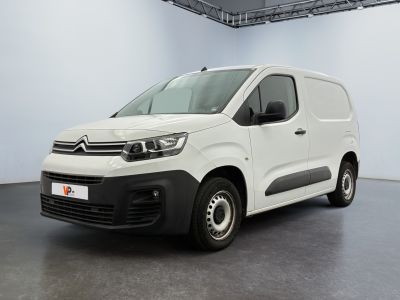 the white van is parked in a large room with a black floor