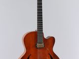 a close up of a guitar on a stand against a white background