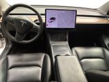 the interior of a tesla vehicle with a touch screen and steering wheel