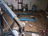 an image of a garage with a crane in the middle of the floor