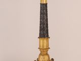 a black and gold candelab with five candles on it
