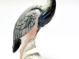 a figurine of a bird that is standing on a rock