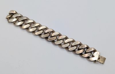 a close up of a silver bracelet on a white surface