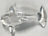 a glass fish shaped object on a white surface