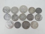 a lot of coins that are on a white surface