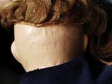 a close up of a doll ' s head with hair in it