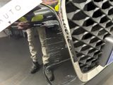 a close up of a car ' s front grill with a sticker on it