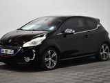 a black car parked in a room with a checkered floor