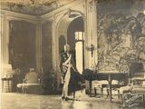 an old photo of a man standing in a room