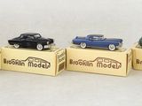 four toy cars are sitting in a row on a box