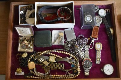 a wooden box filled with assorted items on a table