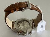 a close up of a watch with a tag on it