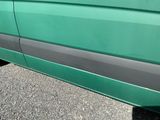a green van parked on the side of the road