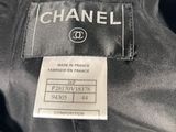 a close up of a chanel label on a black jacket