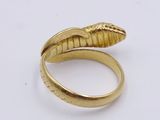 a close up of a gold ring with a snake ' s head on it