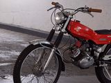 a red motorcycle that is parked in a garage