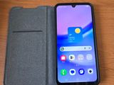 un gros plan d'un téléphone portable posé sur une table, à côté d'un portefeuille