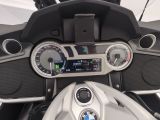 a close up of a motorcycle dashboard with a clock on it