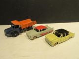 four toy cars sitting next to each other on a table