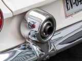 a close up of a car ' s rear end with a chrome exhaust pipe
