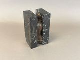 statue of a woman sitting on a bookend with a marble base