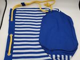 blue and white striped swim suit with a hat on a table
