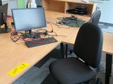 a desk with two computers and a monitor on it