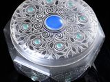 a glass box with a blue stone inside of it