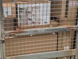 a large metal cage with a bunch of boxes inside of it