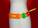 a white mannequin torso with a colorful belt on it