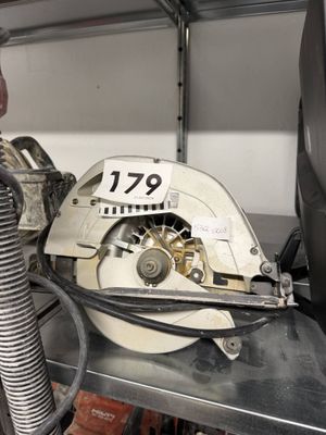 a man using a circular saw to cut a piece of metal