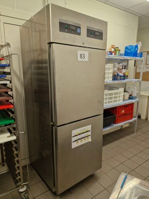a refrigerator in a kitchen with a lot of food on the shelves