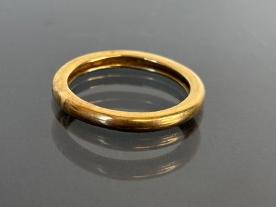 an image of a gold ring sitting on top of a table