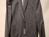 the suit is hanging on a hanger on the wall