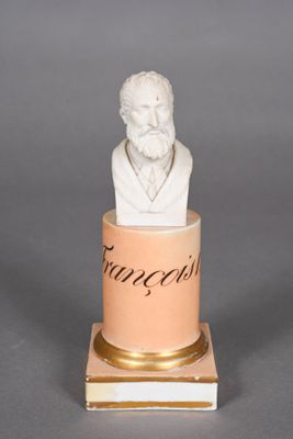 a statue of a man with a beard sitting in a cup