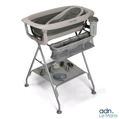 a baby ' s changing table with a baby in it