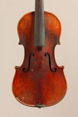 an old violin with a bow hanging from it ' s back